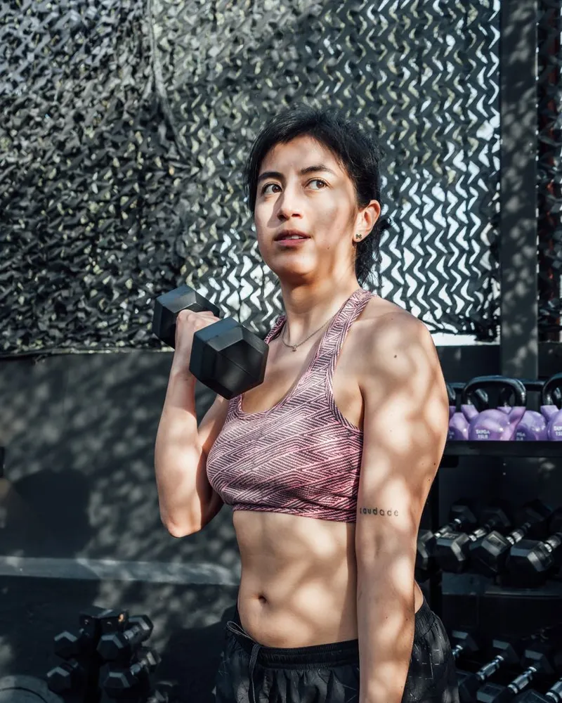 Mulher levantando um halter na academia